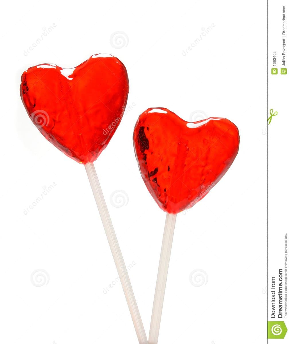 A stock photo showing two glossy, red heart-shaped lollipops on white sticks against a white background. The image includes watermarks and a sidebar from Dreamstime.com.