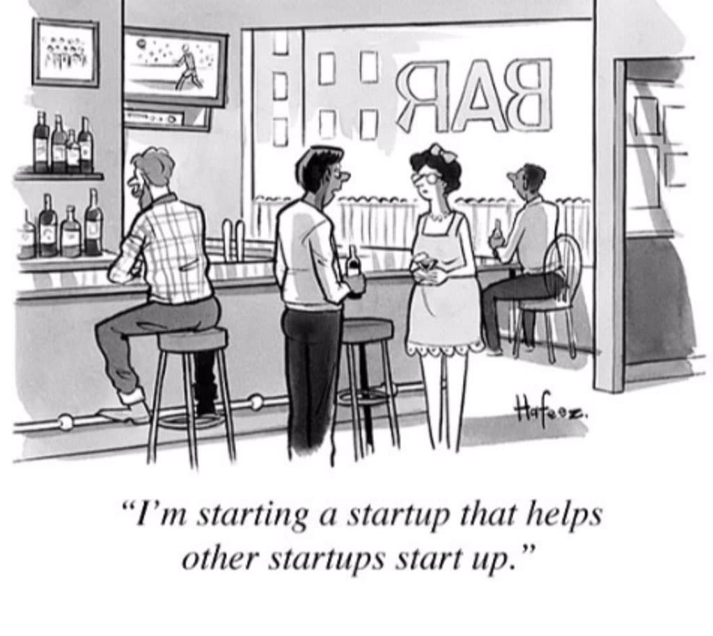 A black-and-white cartoon depicting a man at a bar talking to a woman, with other patrons in the background. The scene is set in a bar, indicated by the word "BAR" on the window and bottles on the shelves. The caption below the image reads: "I'm starting a startup that helps other startups start up."