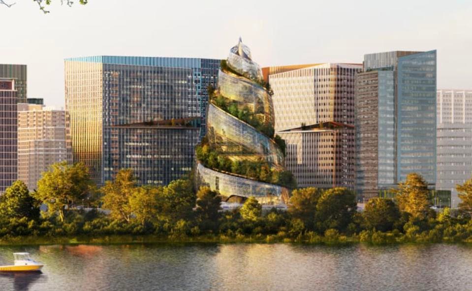 A digital rendering of a futuristic, spiral-shaped glass building with integrated greenery, situated on a waterfront surrounded by modern office towers. The structure resembles a large crystal swirlie and is set against a city skyline with a body of water in the foreground.