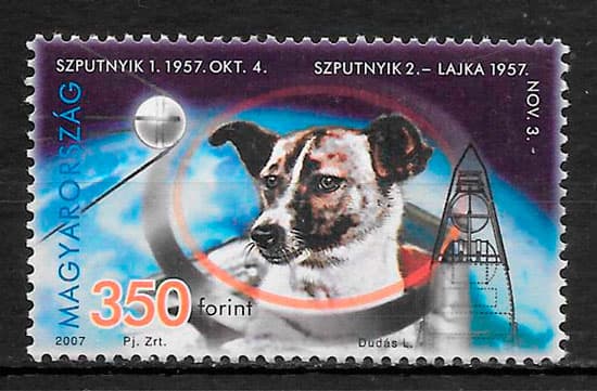 A Hungarian postage stamp featuring a portrait of a dog in a space suit, with a rocket and space-themed background. The stamp commemorates the first and second Hungarian space dogs, Szputnyik 1 and Lajka.