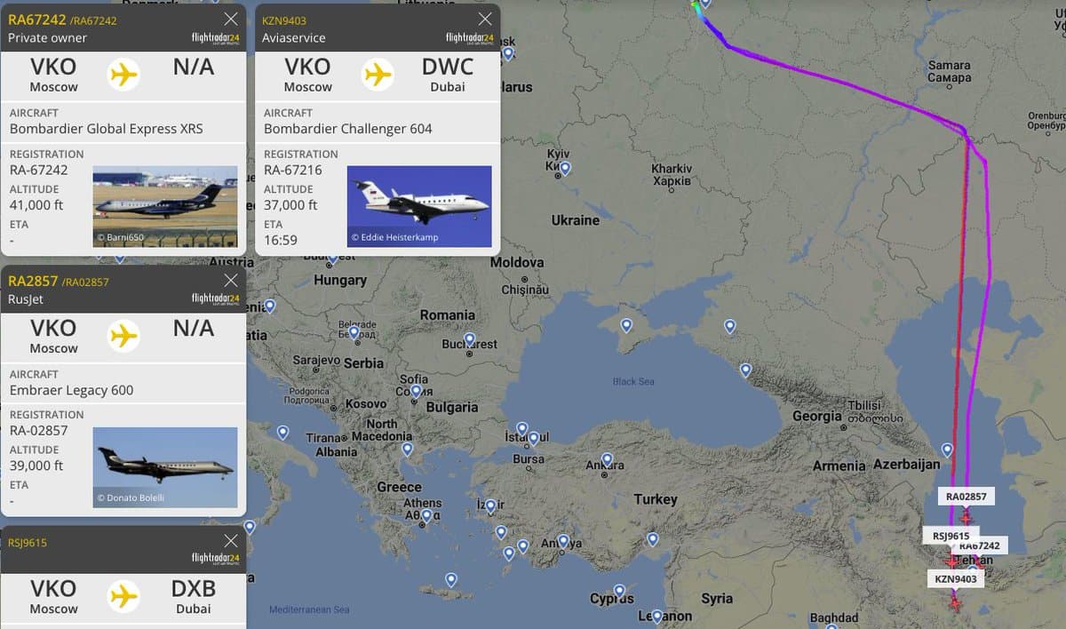 A screenshot of the FlightRadar24 flight tracking application displaying a map of Eastern Europe and the Middle East with flight paths from Moscow to Dubai. Several pop-up panels on the left provide details for specific private jets, including their aircraft type, registration, and altitude.