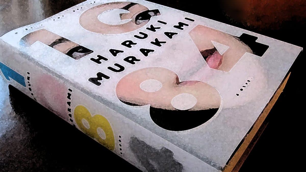 A photograph of the book '1Q84' by Haruki Murakami, showing the cover and spine with a distinctive cut-out design.