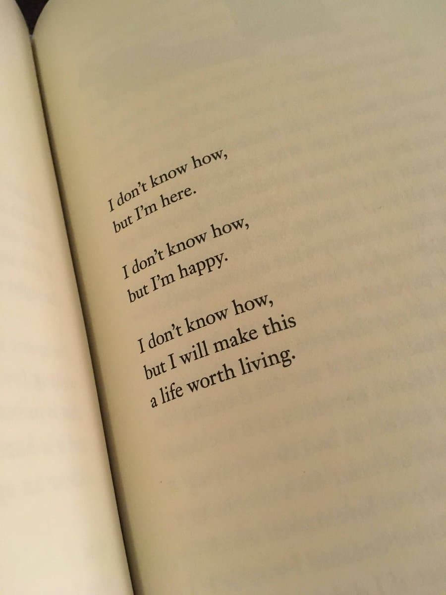 A close-up photograph of an open book page featuring a short, inspirational poem printed in black text on cream-colored paper.