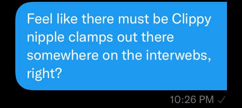 A screenshot of a text message conversation showing a single blue message bubble on a black background. The message reads: "Feel like there must be Clippy nipple clamps out there somewhere on the interwebs, right?" Below the bubble, the timestamp "10:26 PM" and a checkmark are visible.