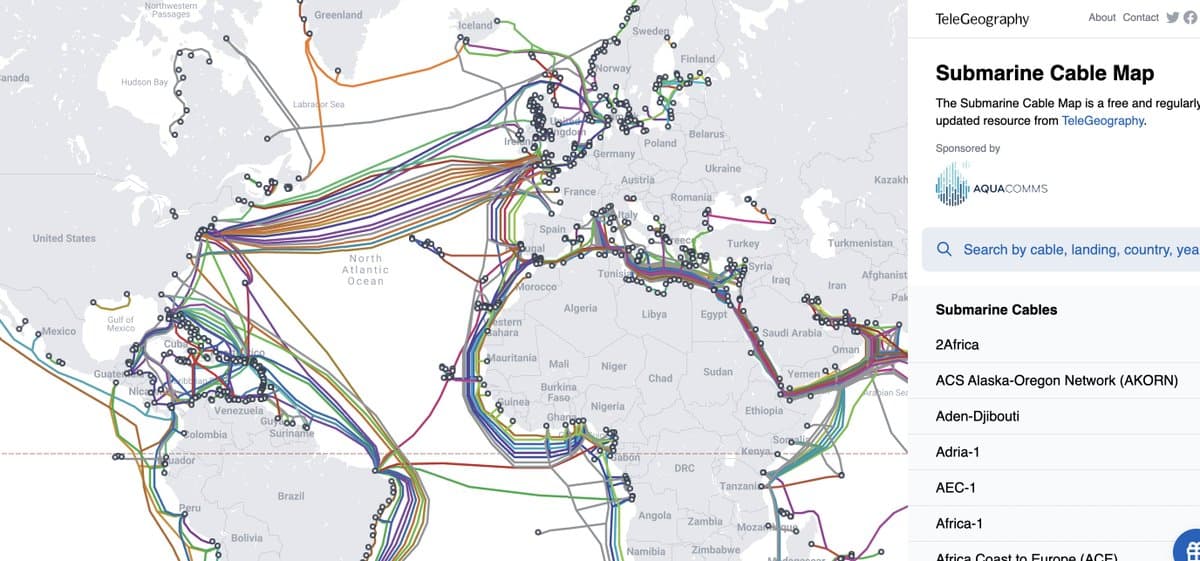 A screenshot of the TeleGeography Submarine Cable Map website, displaying a world map with numerous colored lines representing undersea cables connecting continents. A sidebar on the right lists cable names and provides a search bar.