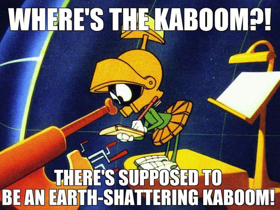 A meme featuring a cartoon robot character from a vintage animation, shown at a desk with a microphone and a lamp. The image has white text overlaid at the top and bottom. Top text: 'WHERE'S THE KABOOM?!' Bottom text: 'THERE'S SUPPOSED TO BE AN EARTH-SHATTERING KABOOM!'