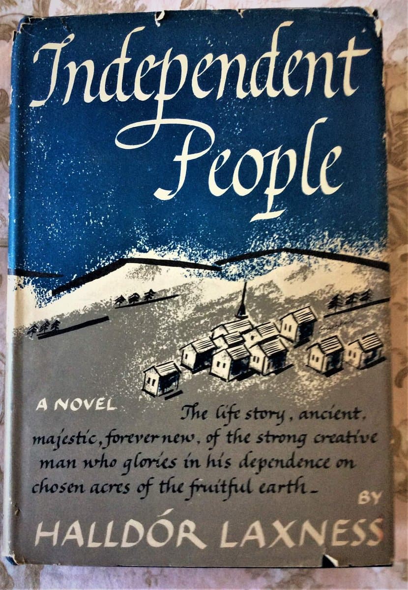 A photograph of the cover of a vintage paperback book titled 'Independent People' by Halldór Laxness. The cover features a blue sky, a snowy landscape with a small village, and descriptive text about the novel's theme.