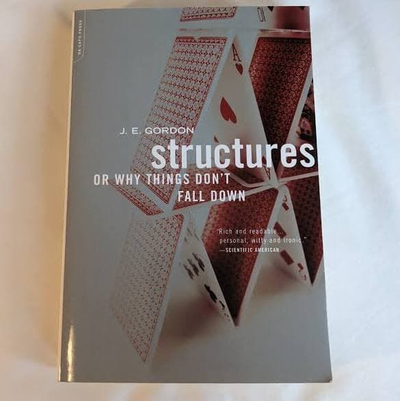 A photograph of the book cover for "Structures" by J. E. Gordon, featuring a house of cards design.