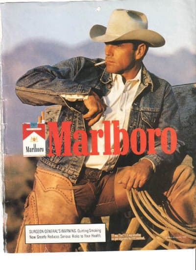 A vintage print advertisement for Marlboro cigarettes featuring a cowboy in a white hat and denim jacket sitting on a horse. The image includes the red Marlboro logo and a Surgeon General's warning box at the bottom.