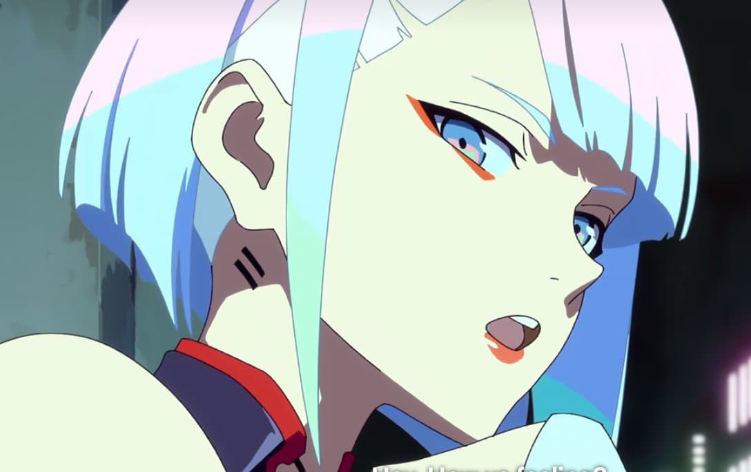 A close-up anime screenshot of a character with short, pastel-colored hair in shades of pink, blue, and white, looking to the side with a surprised expression.