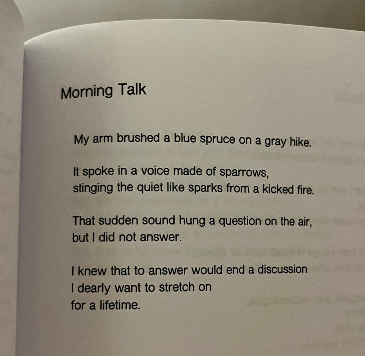 A close-up photograph of an open book page displaying a poem titled "Morning Talk". The text is printed in black on white paper.