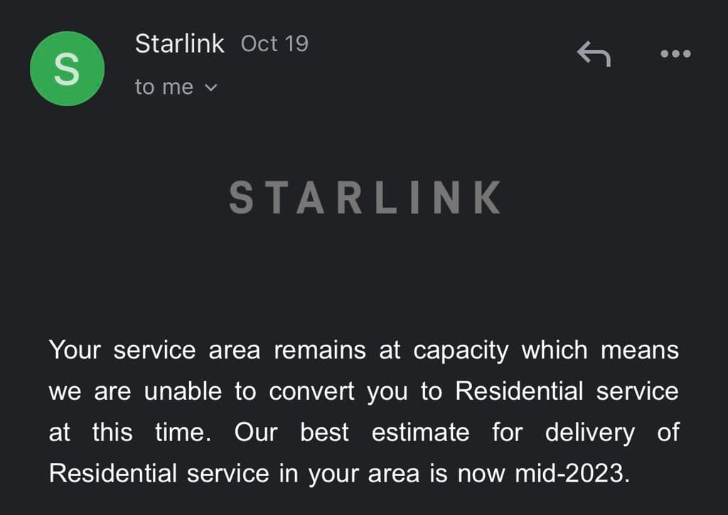 A screenshot of a Starlink email notification dated October 19, informing the recipient that their service area is at capacity and they cannot be converted to Residential service until mid-2023.