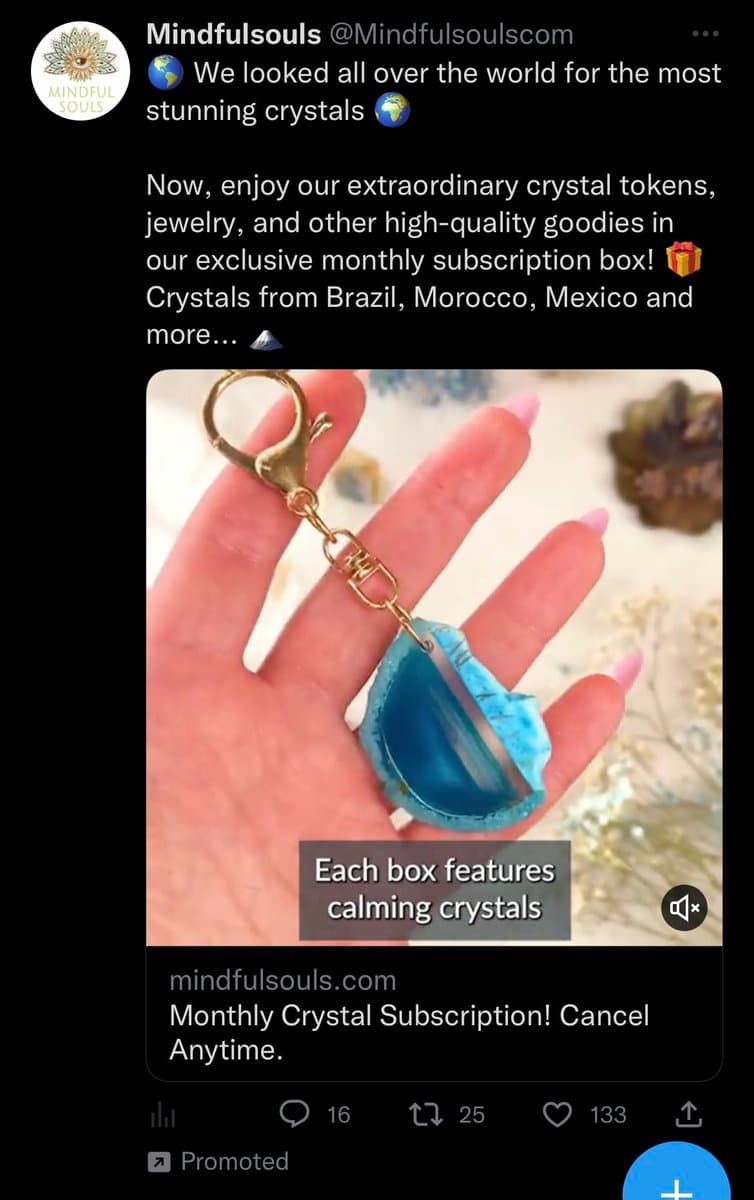 A screenshot of a promoted tweet from the account Mindfulsouls, which advertises a monthly crystal subscription box. The tweet includes a photo of a hand holding a blue crystal keychain, with overlaid text and a link to the company's website.
