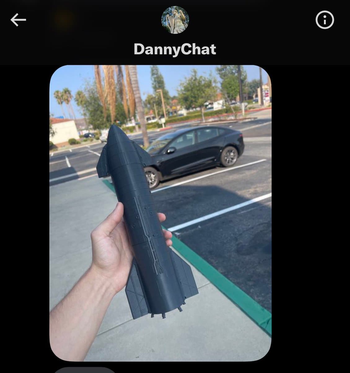 A screenshot of a social media profile page for a user named DannyChat, featuring a photo of a person holding a large, black 3D-printed model of a rocket in a parking lot. The background shows a black car and palm trees under a clear sky.