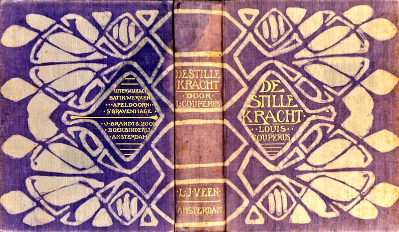 A photograph of a vintage book cover and spine featuring a purple and cream Art Nouveau design with stylized floral motifs. The cover displays the title and author information in a diamond-shaped frame.