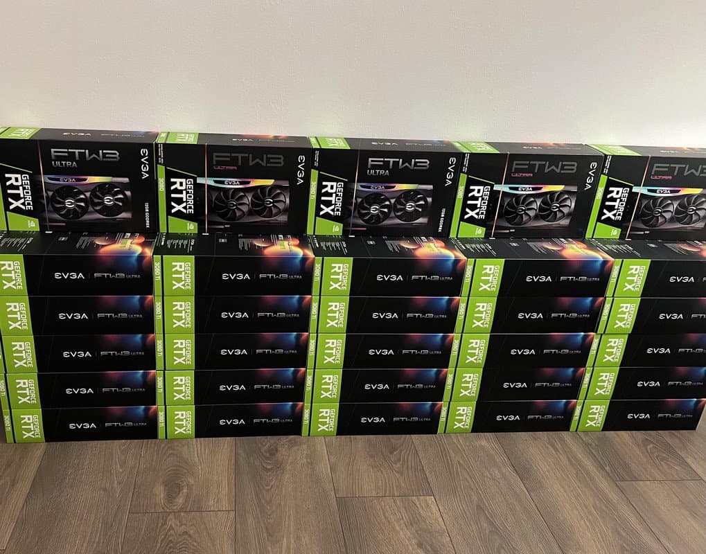 A large stack of EVGA GeForce RTX 3080 FTW3 Ultra graphics card boxes arranged in a grid on a wooden floor. The boxes are black with green accents and feature images of the triple-fan GPU design.