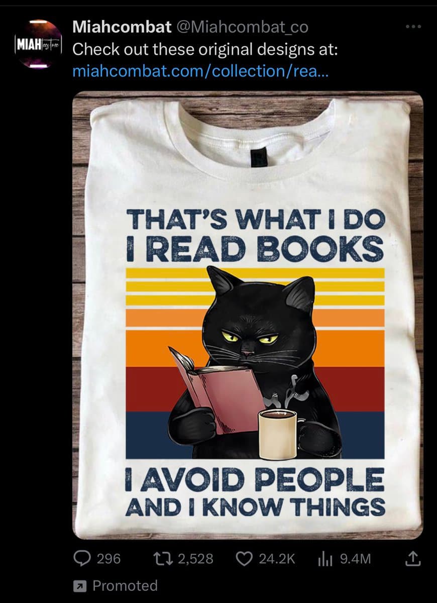 A screenshot of a Twitter post by user Miahcombat, featuring a promotional image of a white t-shirt. The shirt displays a graphic of a black cat reading a book and holding a mug, set against a retro sunset background, with the text "THAT'S WHAT I DO I READ BOOKS I AVOID PEOPLE AND I KNOW THINGS".