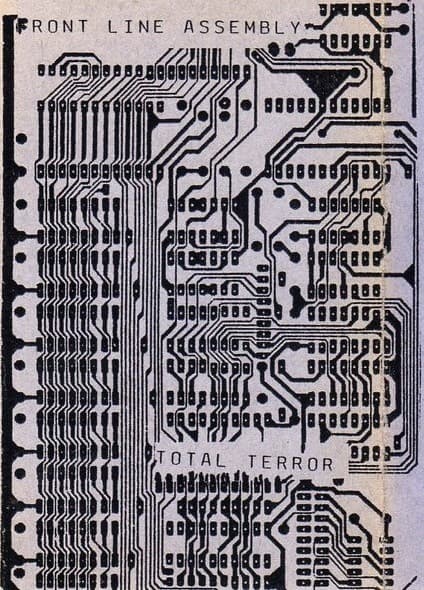 A black-and-white photograph of a printed circuit board (PCB) featuring intricate wiring patterns and solder points. The image includes text printed on the board itself, with "FRONT LINE ASSEMBLY" at the top and "TOTAL TERROR" near the bottom.