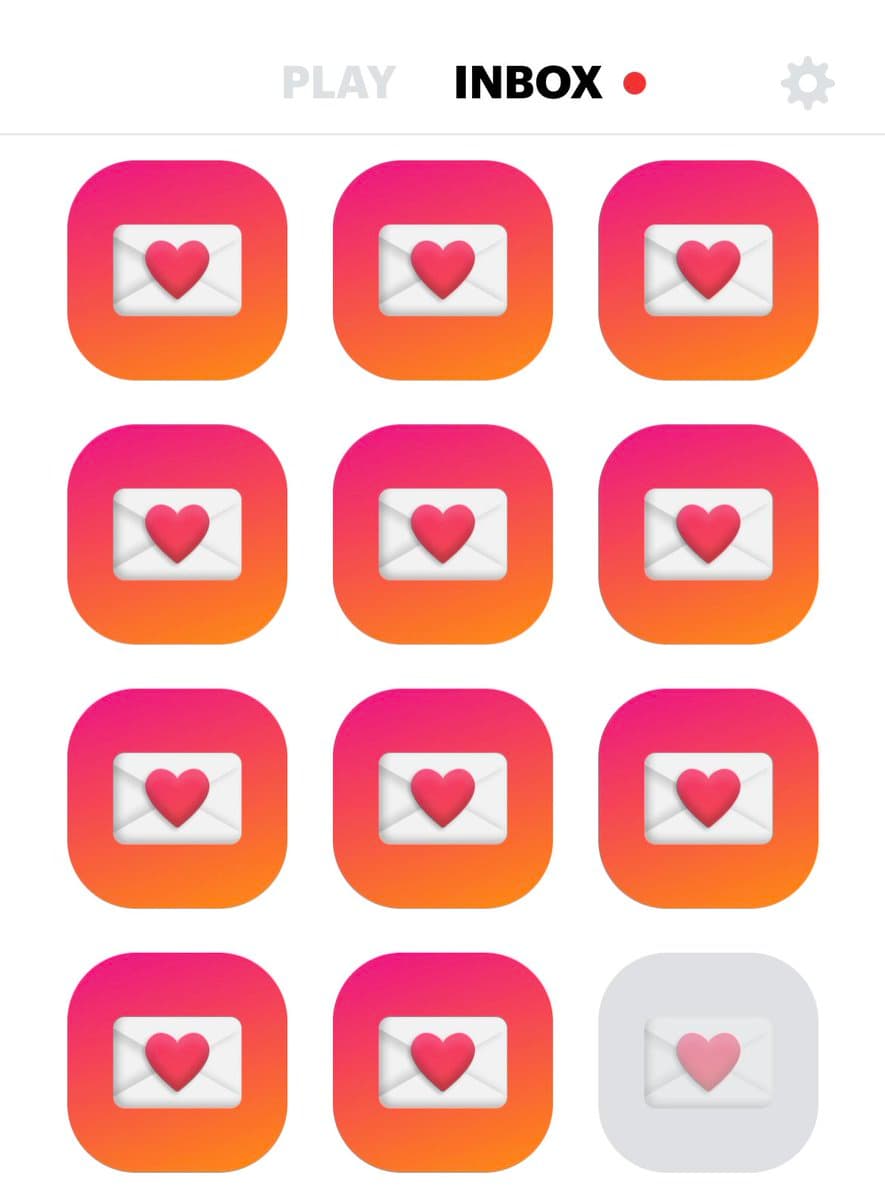 A screenshot of a mobile app interface showing a grid of twelve icons. Eleven icons are pink-to-orange gradient squares with a white envelope and red heart, while the bottom-right icon is a faded gray version. The top bar displays the words 'PLAY' and 'INBOX' with a red notification dot, alongside a settings gear icon.