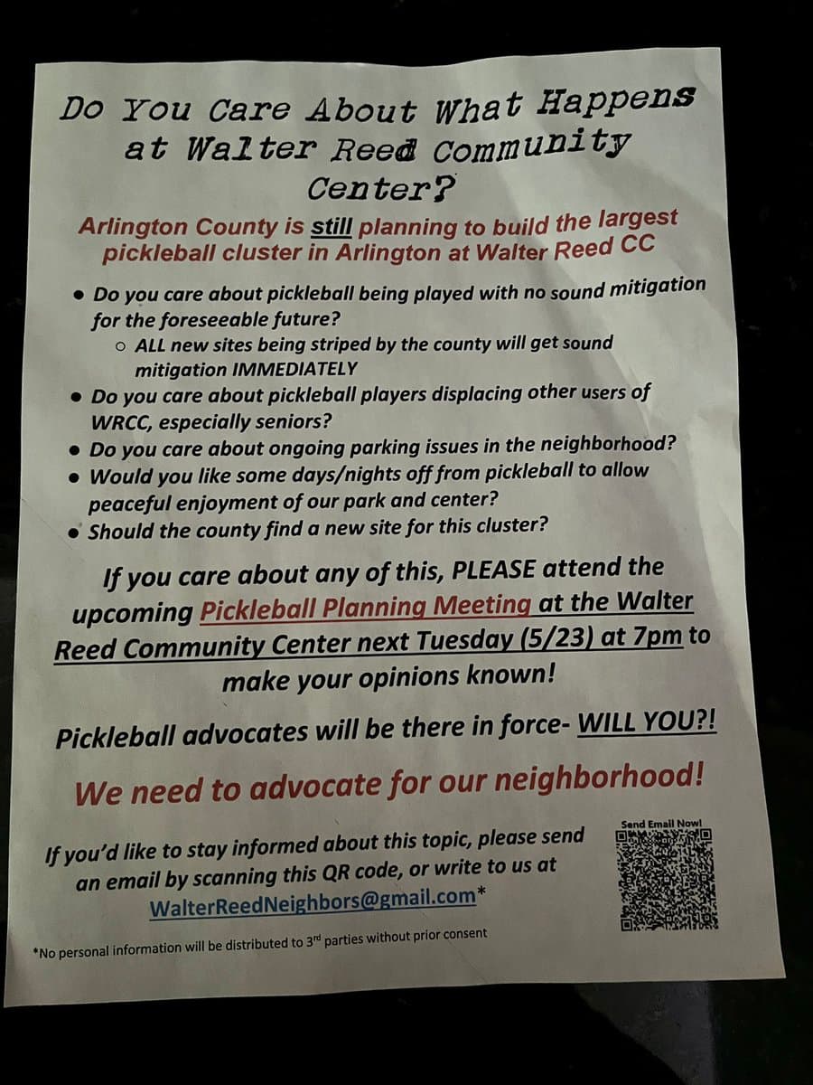 A photograph of a printed flyer taped to a dark surface, likely a car window. The flyer is a community notice opposing the construction of a pickleball cluster at the Walter Reed Community Center in Arlington County, urging residents to attend a planning meeting.