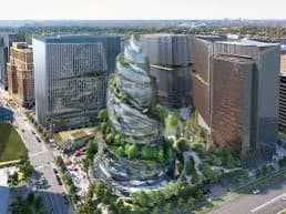 A digital rendering of a modern urban development featuring a central, spiraling tower covered in greenery, surrounded by other high-rise buildings and city streets.