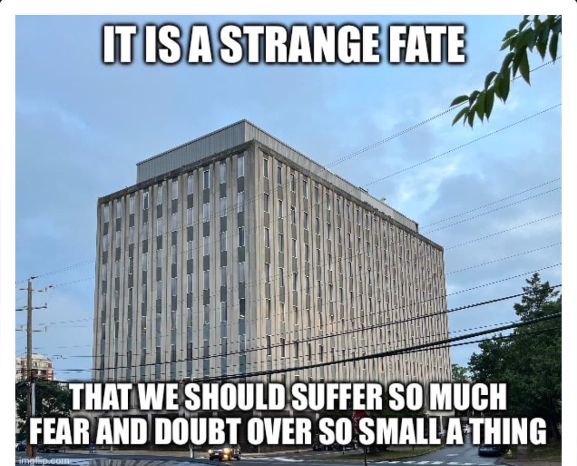 A meme featuring a photo of a tall, multi-story concrete building with vertical window columns, set against a cloudy sky with power lines in the foreground. White Impact-style text is overlaid at the top and bottom of the image.