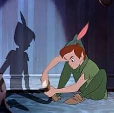 A still from an animated film showing a small, elf-like character in a green outfit crouching on the floor while holding a lit candle. The character's shadow is cast on the wall behind them, appearing as a dark silhouette with pointed ears.