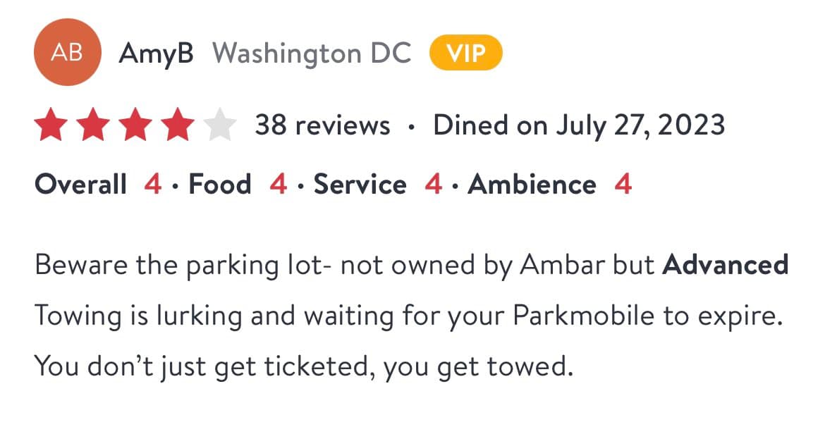 A screenshot of a four-star Yelp review by user AmyB (Washington DC) for a restaurant, warning about a nearby parking lot. The review notes that the lot is not owned by the restaurant (Ambar) but is monitored by Advanced Towing, which tows cars once their Parkmobile time expires.