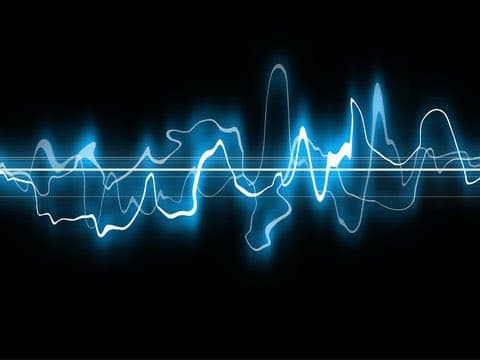 A digital illustration of a glowing blue audio waveform or sound wave against a black background. The image features multiple overlapping lines with varying amplitudes, creating a sense of depth and movement.