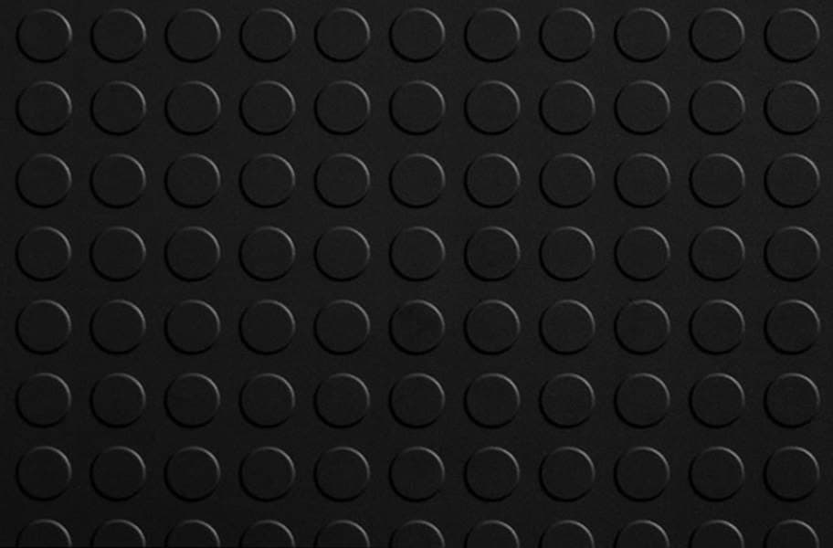 A close-up view of a black, textured surface featuring a grid of raised circular studs, resembling a LEGO baseplate.
