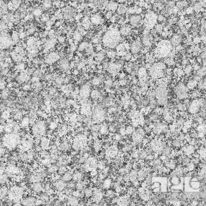 A close-up, full-frame photograph of a speckled granite or stone surface in shades of gray and white. The image features a repeating watermark pattern and a logo in the bottom right corner, indicating it is a stock photo.