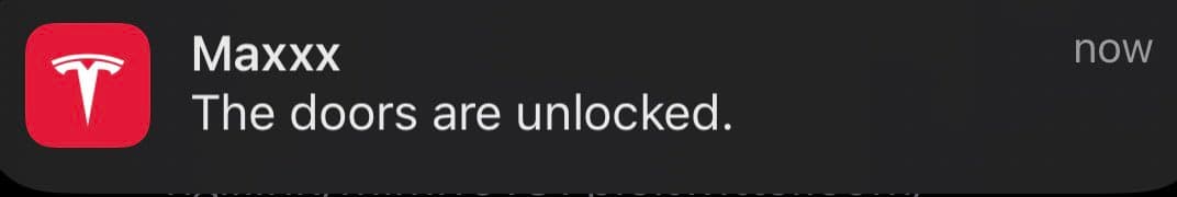 A screenshot of a push notification from the Tesla app on a dark background. The notification displays the Tesla logo, the sender name 'Maxxx', and a message about the car's doors.
