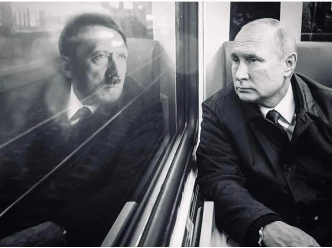 A black and white photograph showing a man sitting on a train, with a reflection of Adolf Hitler visible in the window beside him.