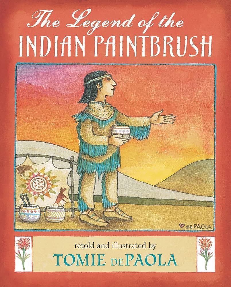 The cover of the children's book 'The Legend of the Indian Paintbrush', featuring a watercolor illustration of a Native American figure holding a bowl against a sunset sky.