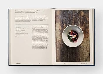 An open cookbook spread featuring a recipe on the left page and a photograph of a white bowl containing a dark dish on the right page.