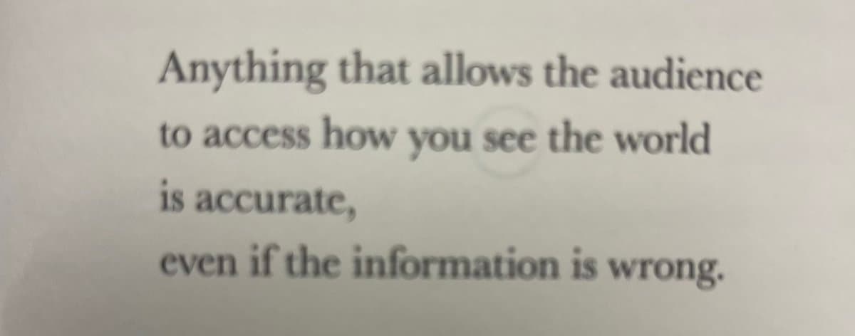 A photograph of a printed or projected text excerpt on a light background. The text is a philosophical or creative-writing statement about accuracy in conveying one's perspective.