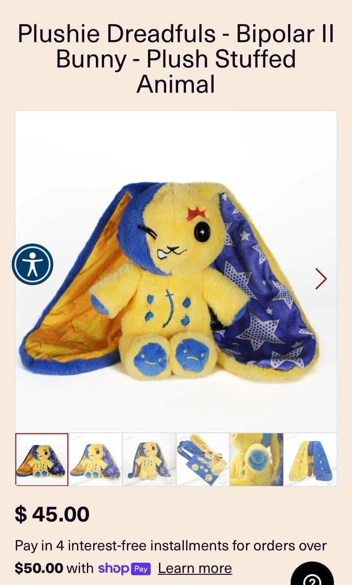A screenshot of an online product listing for a stuffed animal. The image shows a yellow and blue plush bunny with a winking face, a red star on its forehead, and a smiley and frowny face on its feet, set against a star-patterned background. Below the main image are smaller thumbnail views of the product and its price.