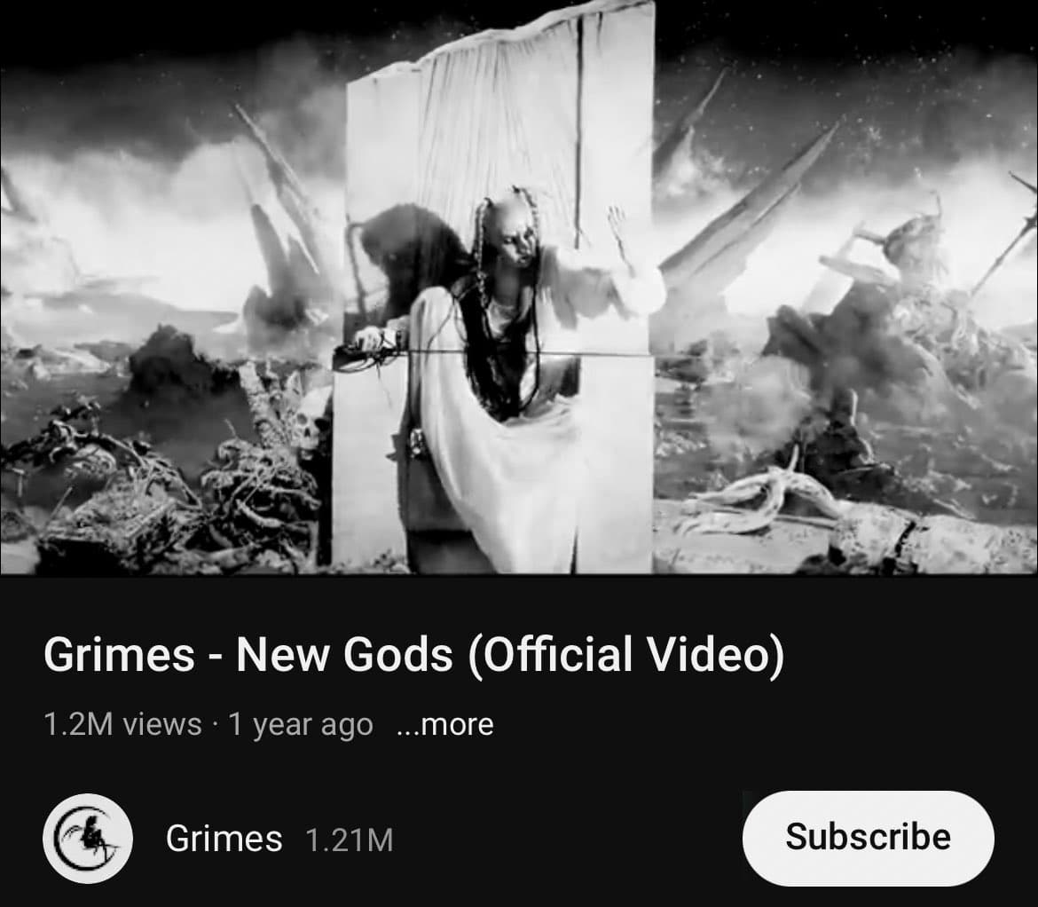 A screenshot of a YouTube video page showing a black-and-white still from a music video. The still features a person in a white robe standing in a chaotic, apocalyptic landscape with debris and smoke. The video is titled "Grimes - New Gods (Official Video)" and has 1.2M views.