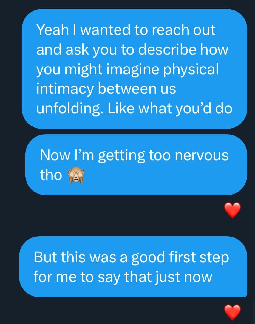 A screenshot of a text message conversation showing three blue message bubbles on a dark background. The messages discuss a person's nervousness about asking someone to describe their imagined physical intimacy, ending with a note that it was a good first step. Red heart emojis appear as reactions to the messages.