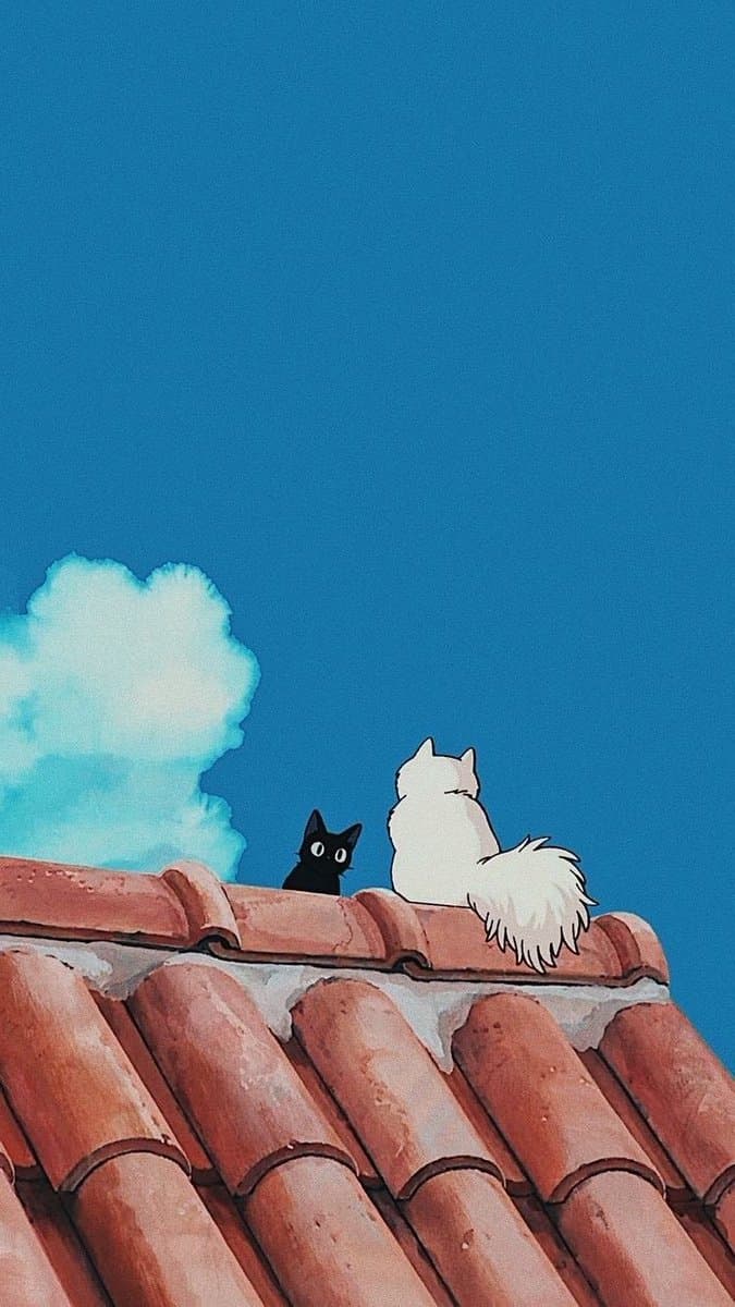 A still from the animated film Kiki's Delivery Service showing a black cat and a white cat sitting on a red-tiled roof against a bright blue sky with a single cloud.