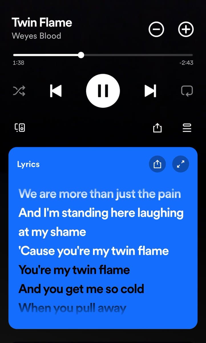 A screenshot of the Spotify mobile app showing the song "Twin Flame" by Weyes Blood playing, with a lyrics panel displayed at the bottom. The lyrics panel is highlighted in blue and shows the current verse.