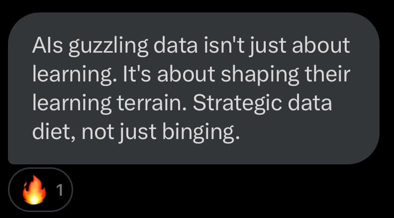 A screenshot of a social media post featuring a dark gray text bubble with white text on a black background. Below the text bubble is a small reaction icon showing a flame emoji with the number 1.