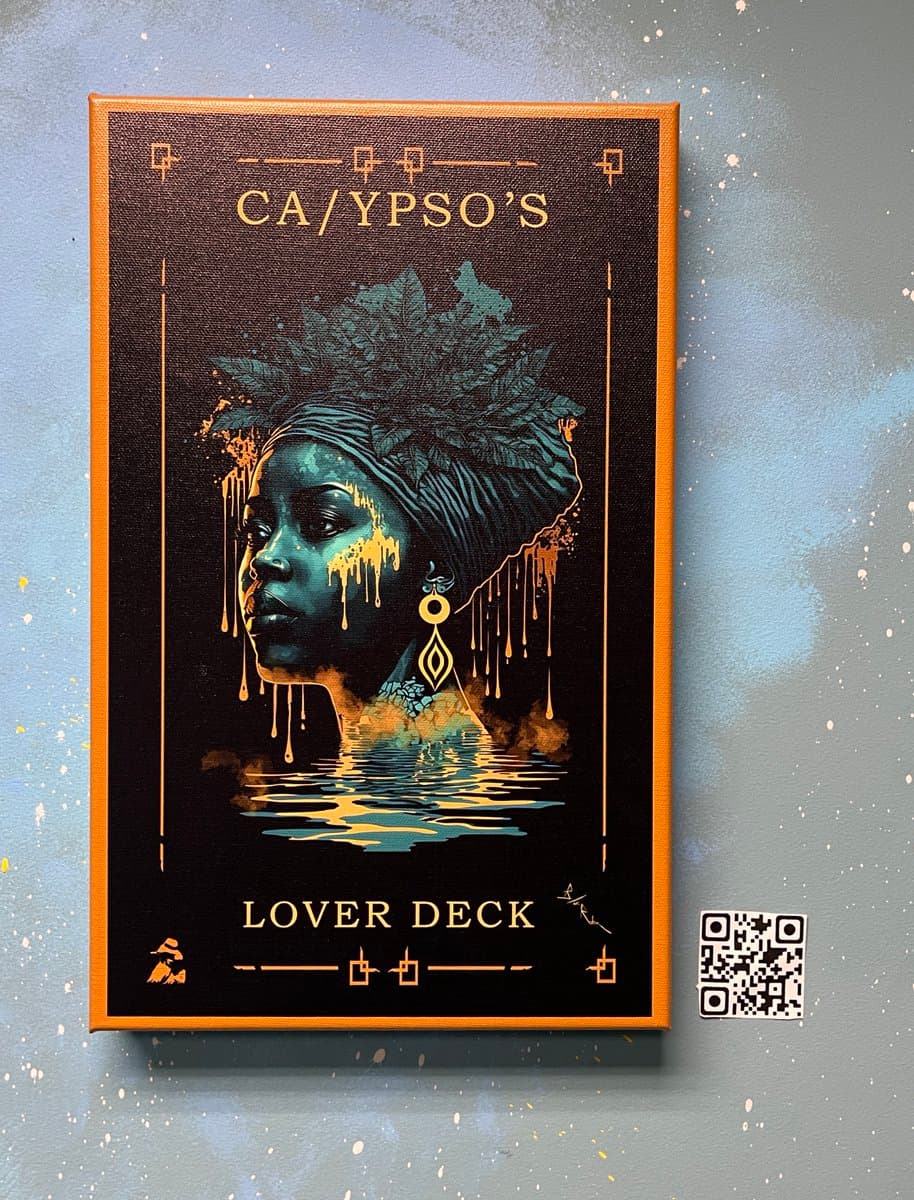 A photograph of a framed art print featuring a stylized illustration of a person with a headwrap and gold accents, set against a black background. The print is titled 'CA/YPSO'S' at the top and 'LOVER DECK' at the bottom, with a QR code visible on the wall to the right.