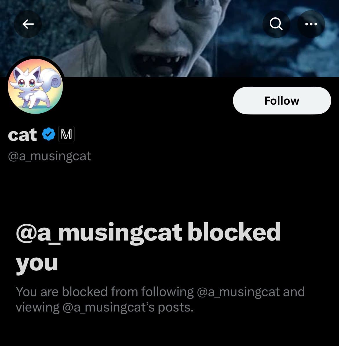 A screenshot of a Twitter profile page showing a 'blocked' notification. The profile belongs to the user 'cat' (@a_musingcat), whose avatar is a white cartoon cat and whose header image is a close-up of a goblin-like character.