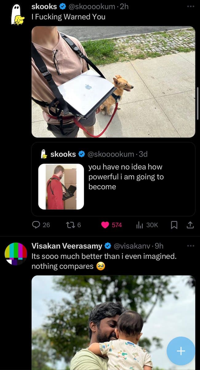 A screenshot of a Twitter conversation featuring a reply to a tweet by user @skooookum. The main tweet shows a person carrying a laptop in a harness while walking a small dog, with the caption 'I Fucking Warned You'. The reply from @visakanv includes a photo of a man holding a baby and the text 'Its sooo much better than i even imagined. nothing compares 🥹'.