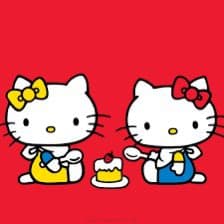 A digital illustration on a red background featuring two Hello Kitty characters sitting opposite each other. The character on the left wears a yellow bow and a yellow dress, while the character on the right wears a red bow and a blue dress. They are seated around a small white table holding a cake with a single candle.