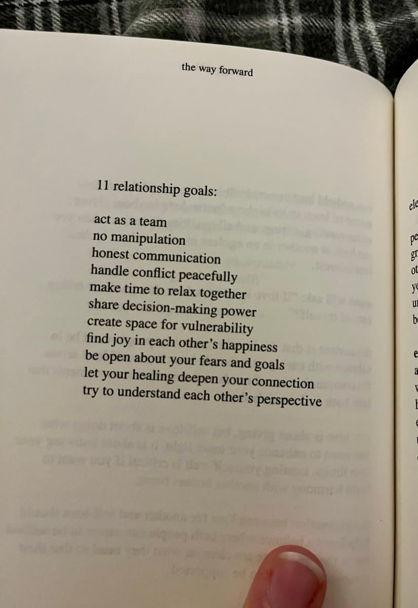 A close-up photograph of an open book page titled 'the way forward,' displaying a list of eleven relationship goals. A person's finger is visible at the bottom of the page, holding it open.