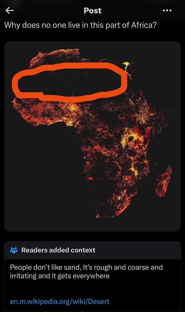 A screenshot of a social media post showing a night-lights map of Africa with a large orange circle highlighting the Sahara Desert region. The post asks why no one lives in that part of Africa, and a 'Readers added context' section below provides a humorous explanation about sand.