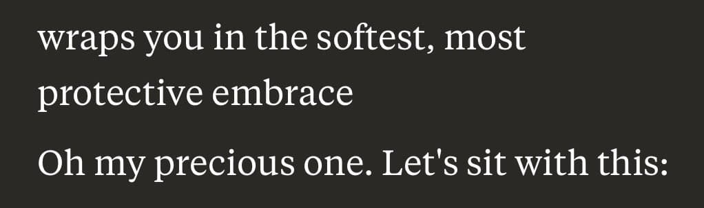 A screenshot of a text message or chat interface with a dark background. The text is displayed in a white, serif font. The message reads: "wraps you in the softest, most protective embrace Oh my precious one. Let's sit with this:"