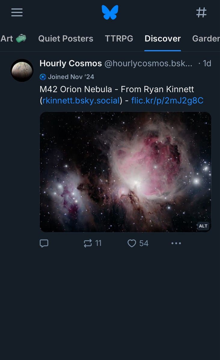 A screenshot of a Bluesky social media app showing a post from the user 'Hourly Cosmos' on the Discover feed. The post features a photograph of the Orion Nebula (M42) with pink and white gas clouds against a starry background.
